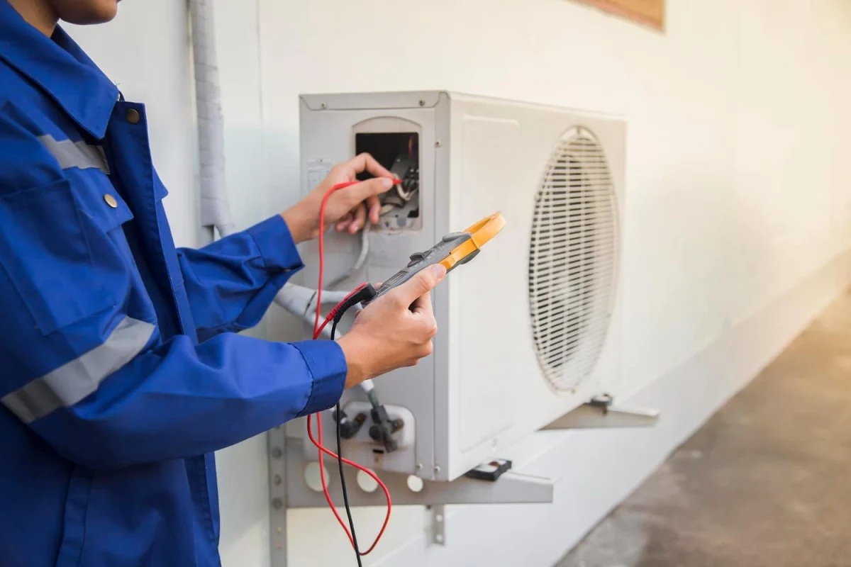 Technician checking air conditioning equipment